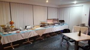 a buffet table with food on it in a room at Water's Edge Hotel in Birżebbuġa