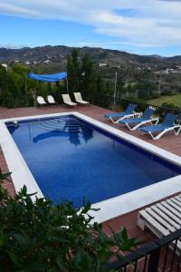 a swimming pool with lounge chairs at Apartamento en Villa con Piscina in Málaga