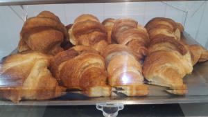 a bunch of croissants on a tray in a bakery at Water's Edge Hotel in Birżebbuġa