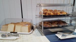 a display of bread and pastries on a counter at Water's Edge Hotel in Birżebbuġa