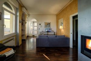 sala de estar con sofá y chimenea en Holiday Treviso Attico Vittoria, en Treviso
