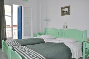 Postel nebo postele na pokoji v ubytování Remezzo Hotel & Studios