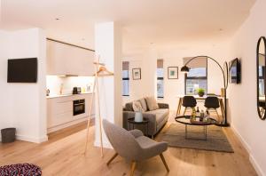 a living room with a couch and a table at Hiding Space Westgate Apartments in Bath