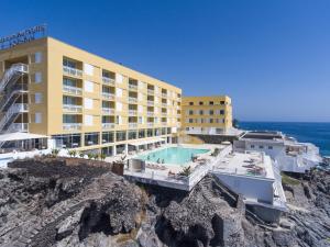 a hotel with a swimming pool next to the ocean at Atlantic Holiday Hotel in Callao Salvaje