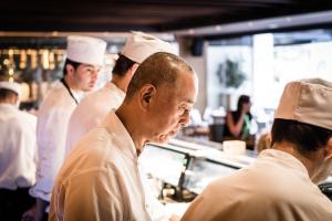 a man in a chef's hat is standing in front of a counter at Nobu Hotel Marbella in Marbella