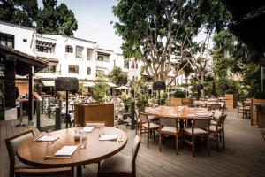 a dining area with tables, chairs, tables and umbrellas at Nobu Hotel Marbella in Marbella