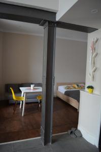 リヴィウにあるSunny Studio in the center of Lvivのベッド1台、テーブル、テーブルトップが備わる客室です。