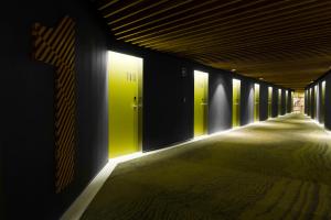 a hallway with green doors in a building at Hotel Rec Barcelona - Adults Only in Barcelona