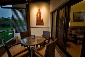 a balcony with a table and chairs on a balcony at The Sunbeam Hideaway B&B in Luodong