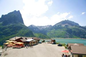a view of a town with mountains and a lake at Appartment Emosson in Finhaut