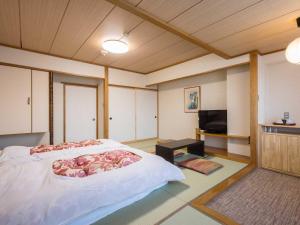 מיטה או מיטות בחדר ב-Hotel Goryukan