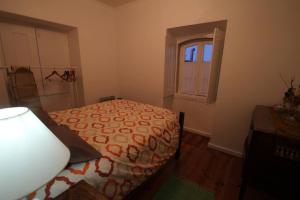 1 dormitorio con cama y ventana en Casas do Patio Sem Cantigas 3, en Sintra