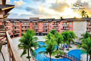 a view of a resort with palm trees and a pool at Kariri Beach Hotel in Cumbuco