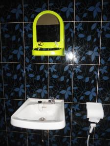 a bathroom with a sink and a mirror on a wall at Bule Homestay Cianjur in Tjiandjur +183 photos