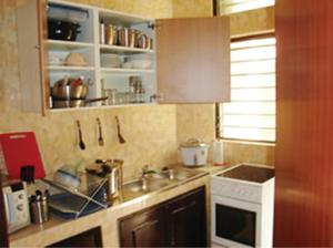 a kitchen with a sink and a counter top at Résidences La Fourmi in Lomé