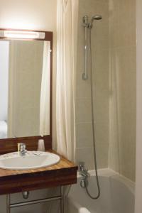 La salle de bains est pourvue d'un lavabo et d'une douche. dans l'établissement Le Relais Du Canalou, à Digoin