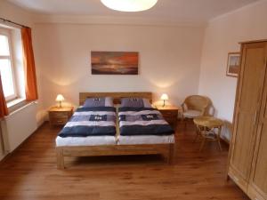 a bedroom with two beds and two chairs in it at Ferienwohnung Hohaus Dresden in Dresden