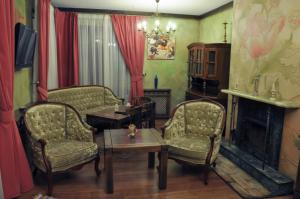 a living room with two chairs and a fireplace at Arthotel Mini-Hotel in Bukovel