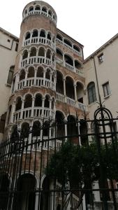 a tall building with a tower on the side of it at Alloggi alla Scala del Bovolo in Venice