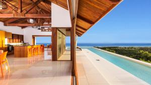 a villa with a swimming pool and a view of the ocean at Private Holiday House in Tangangge