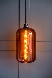 a glass light fixture hanging from a ceiling at The Swan Hotel in Southwold