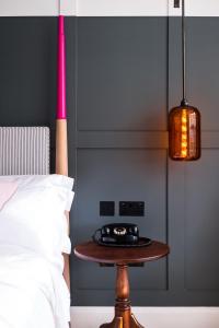a bedroom with a table next to a bed at The Swan Hotel in Southwold
