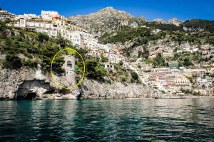 a view of positano from the water at Villa Torre Trasita luxury suites in Positano