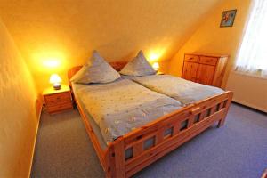 グロース・ノメローにあるFerienwohnung Gro_ Nemerow SEE 3871のベッドルーム1室(白いシーツと枕が備わる木製ベッド1台付)