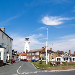 a lighthouse in the middle of a town with houses at The Swan Hotel in Southwold