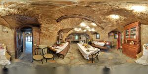 jadalnia ze stołami i krzesłami w ceglanej ścianie w obiekcie B&B I Colori dell'Arcobaleno w mieście Belvedere Langhe