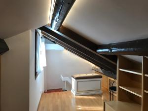 a attic room with a staircase and a window at Cà Nova in Venice