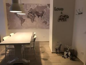 a dining room with a table and a map on the wall at Piano B Apartment in Trento