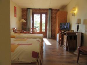 Postel nebo postele na pokoji v ubytování Hotel De Watermolen