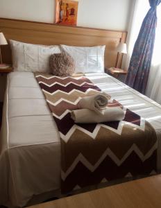 a bed with two folded towels on it at Hae Bed and Breakfast in Leribe