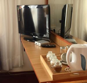 a desk with a monitor and a computer on it at Hae Bed and Breakfast in Leribe