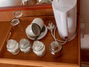 a counter with a mixer and jars on it at Hae Bed and Breakfast in Leribe