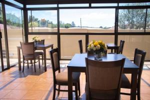a restaurant with tables and chairs with flowers on them at Riverton Manor in Centurion