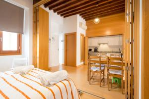 a bedroom with a large bed and a kitchen at A dos pasos de Todo in Málaga +46 photos
