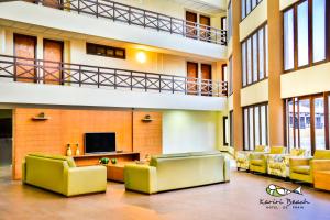 a lobby with couches and a television in a building at Kariri Beach Hotel in Cumbuco