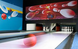 a bowling alley with a ball on the lanes at LIPNO WELLNESS - FRYMBURK HOTEL private family room in Frymburk