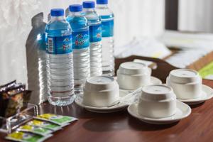 a table with plates and bottles of water on it at Lishin Hotel in Hualien City