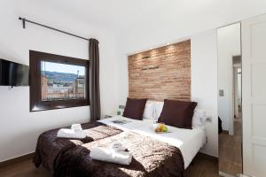 a bedroom with a bed with two towels on it at AB Paral·lel Spacious Apartments in Barcelona