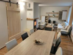 a dining room and living room with a table and chairs at Cottage Refresh in Banská Štiavnica