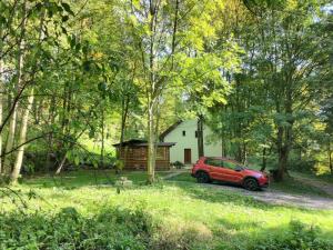 un coche rojo estacionado frente a una casa en Cottage Refresh en Banská Štiavnica