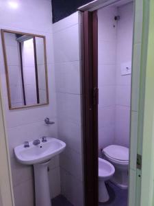 a bathroom with a sink and a toilet at Hotel Atlantic in Mar del Plata