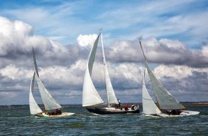 three sailboats in the water under a cloudy sky at The retreat in West Mersea