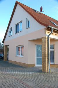 a house with a red roof and a brick driveway at Ferienwohnung Prey in Ueckermünde