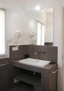 baño con lavabo y espejo grande en Residenza Pellacani, en Bolonia