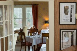 a dining room with a table with wine glasses on it at Sugar Hill Inn in Sugar Hill