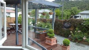 a view of a patio with a table and a fence at Al and Rosies B+B in Greymouth